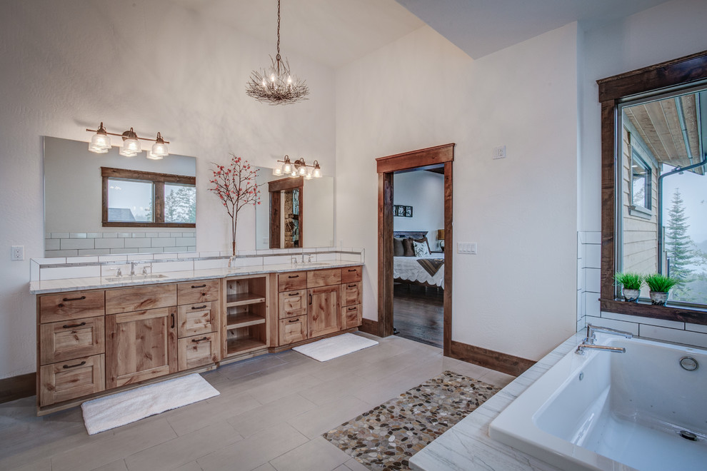 This is an example of a large country master bathroom in Seattle with a drop-in sink, shaker cabinets, medium wood cabinets, granite benchtops, a drop-in tub, an open shower, white tile, subway tile, white walls and ceramic floors.