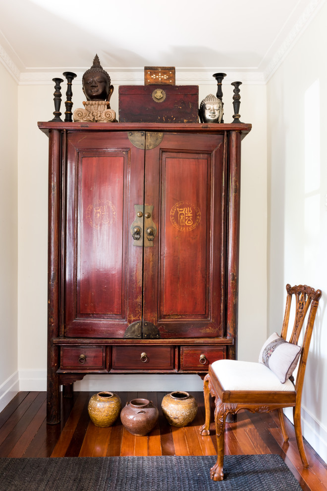 This is an example of a mid-sized asian foyer in Brisbane with white walls, medium hardwood floors, a single front door, a blue front door and brown floor.