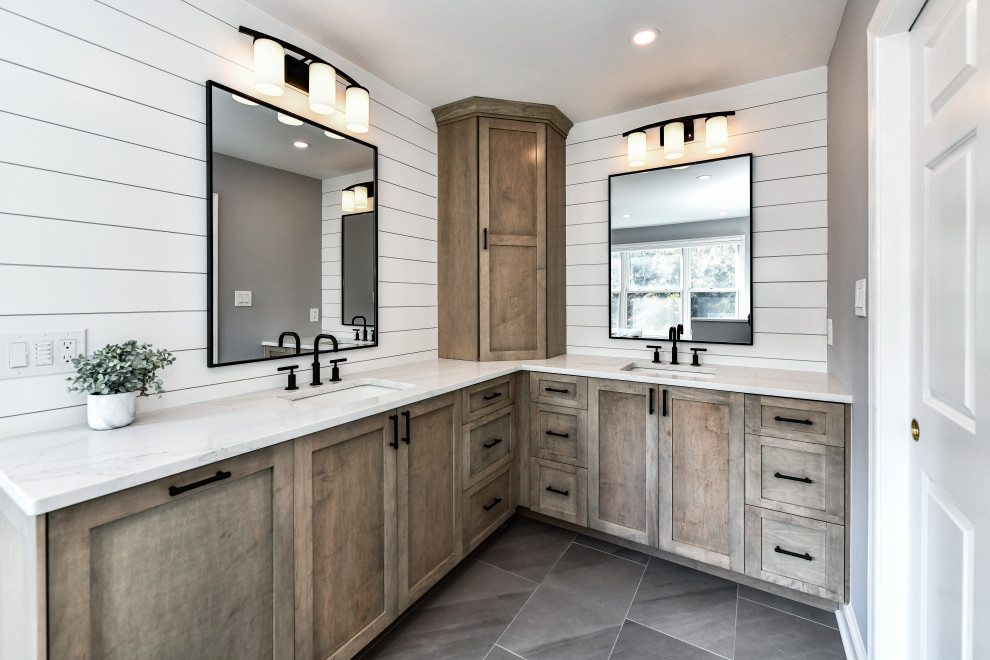 This is an example of a mid-sized beach style master bathroom in DC Metro with shaker cabinets, medium wood cabinets, white walls, porcelain floors, an undermount sink, engineered quartz benchtops, grey floor, white benchtops, a double vanity, a built-in vanity and planked wall panelling.