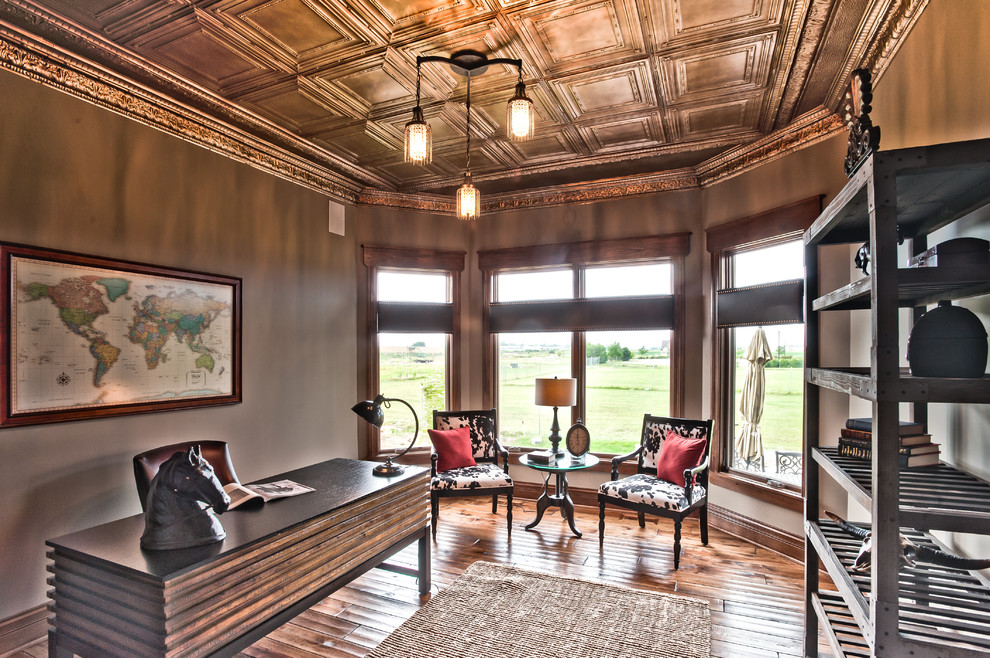 Inspiration for a mid-sized rustic freestanding desk light wood floor study room remodel in Chicago with beige walls