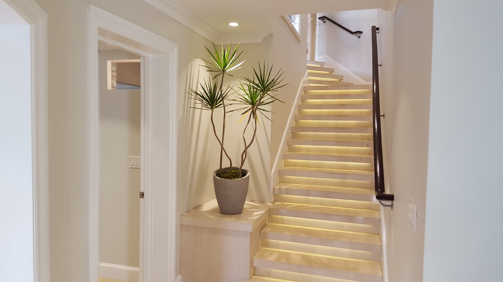 Inspiration for a mid-sized tropical limestone straight staircase in Other with limestone risers and wood railing.