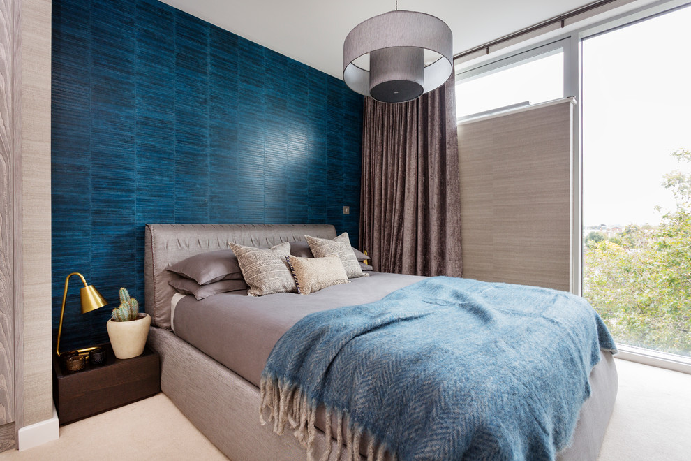 This is an example of a mid-sized contemporary bedroom in London with carpet.