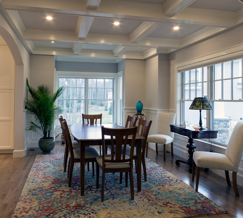 This is an example of a traditional dining room in Portland Maine with grey walls and brown floor.
