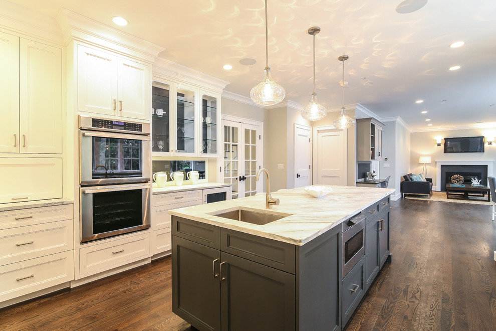 Inspiration for a large transitional u-shaped open plan kitchen in New York with flat-panel cabinets, white cabinets, marble benchtops and with island.