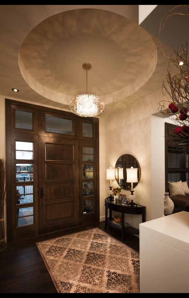Example of a transitional dark wood floor home design design in Calgary with beige walls and a dark wood front door