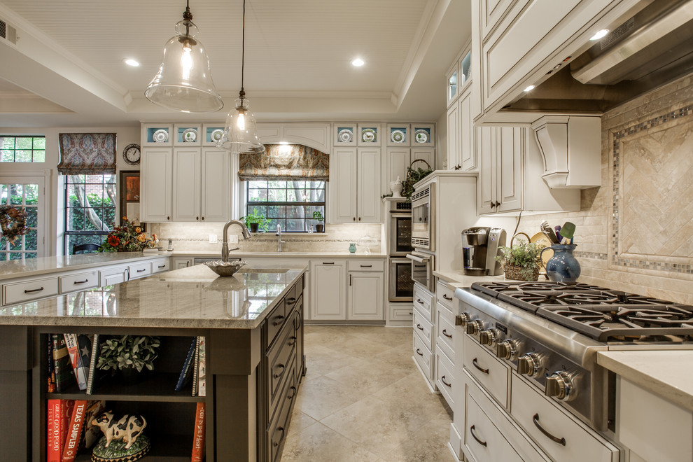 Design ideas for a mid-sized transitional u-shaped separate kitchen in Dallas with an undermount sink, raised-panel cabinets, white cabinets, granite benchtops, beige splashback, ceramic splashback, stainless steel appliances, ceramic floors, with island and beige floor.