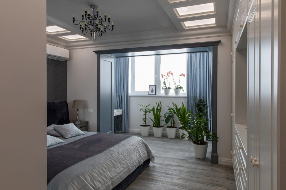 Inspiration for a mid-sized transitional master bedroom in Other with white walls, laminate floors and grey floor.
