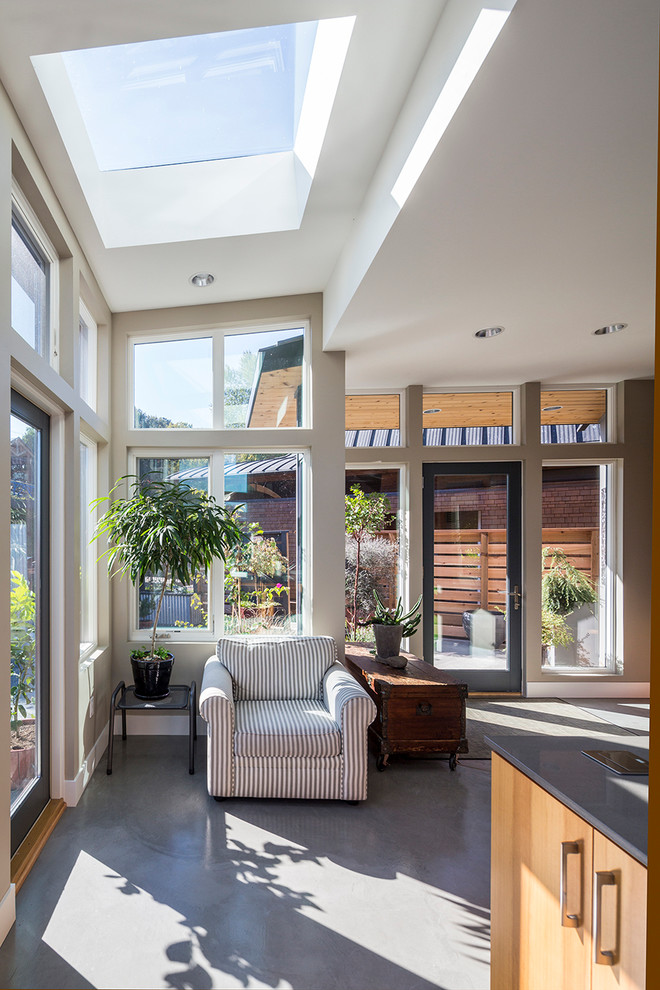 Photo of a mid-sized contemporary sunroom in Portland with concrete floors and a skylight.