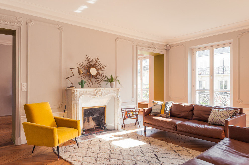 Large contemporary formal enclosed living room in Paris with beige walls, medium hardwood floors, a standard fireplace, a stone fireplace surround and no tv.