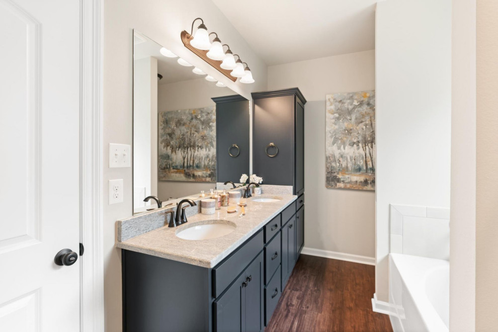 Mid-sized elegant master dark wood floor, brown floor and double-sink bathroom photo in Other with blue cabinets, white walls, granite countertops, white countertops and a built-in vanity