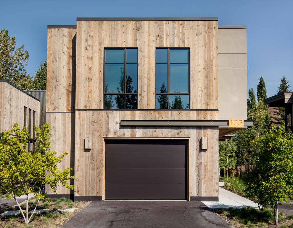 Design ideas for a contemporary two-storey exterior in Boise with wood siding and a flat roof.