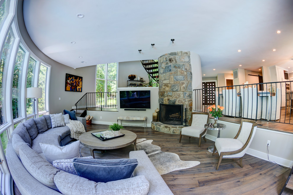Photo of a large transitional open concept family room in DC Metro with grey walls, dark hardwood floors, a standard fireplace, a stone fireplace surround, no tv and brown floor.