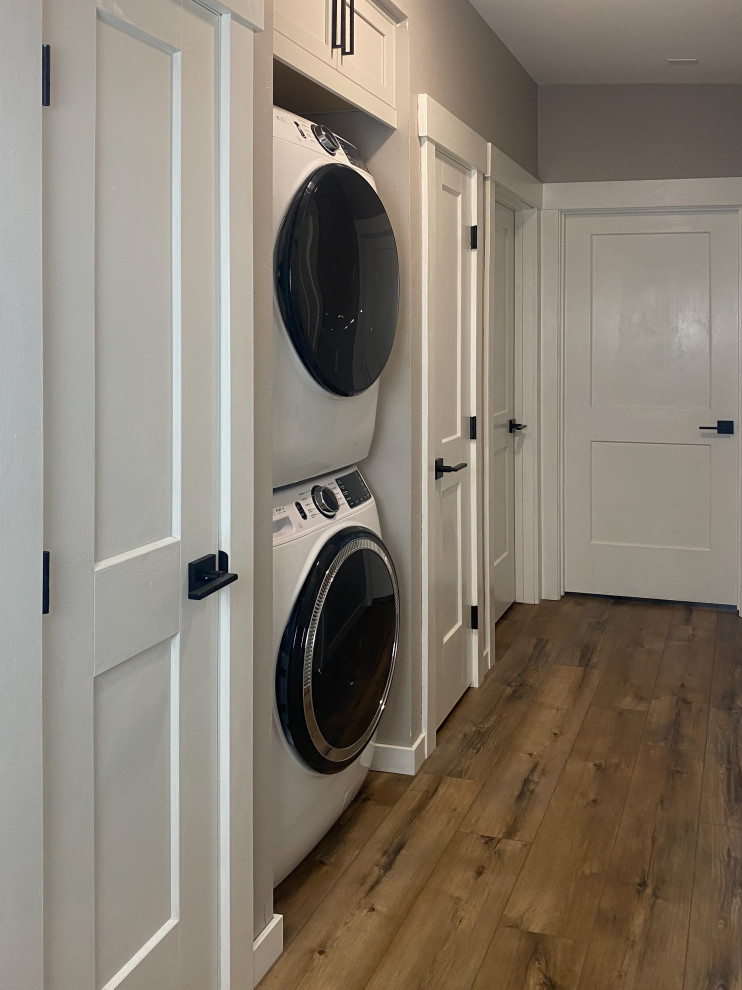 Inspiration for a mid-sized transitional laundry room remodel in Albuquerque with white cabinets and beige countertops