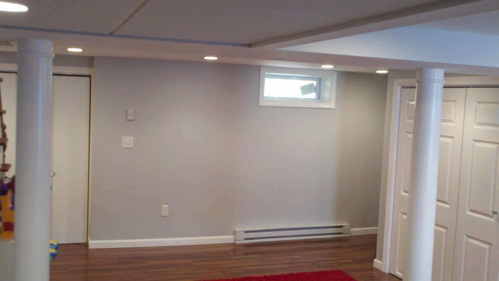 Photo of a small traditional look-out basement in Bridgeport with blue walls, dark hardwood floors and no fireplace.