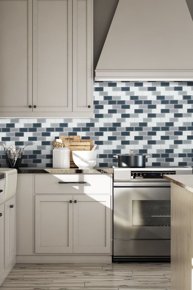 Enclosed kitchen - mid-sized transitional l-shaped light wood floor and brown floor enclosed kitchen idea in Miami with shaker cabinets, white cabinets, quartzite countertops, mosaic tile backsplash, stainless steel appliances, an island, a farmhouse sink, multicolored backsplash and gray countertops