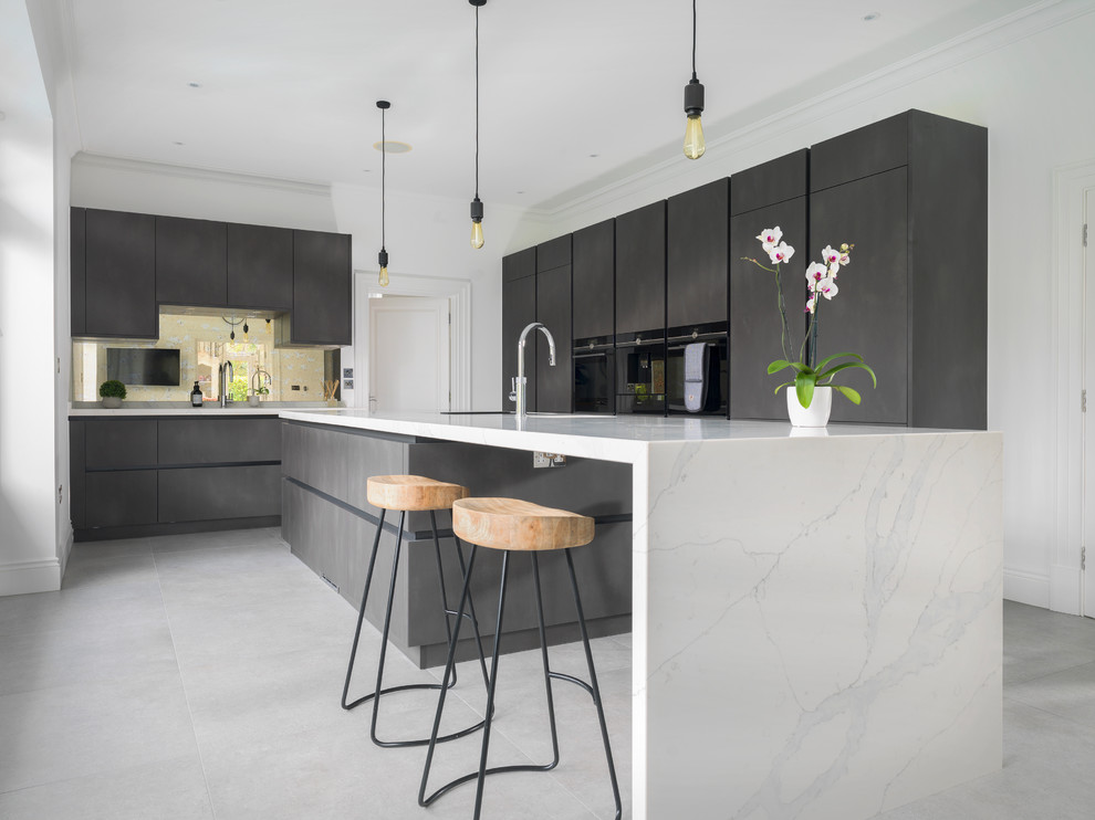 Design ideas for a contemporary l-shaped kitchen in Other with flat-panel cabinets, marble benchtops, black appliances, with island, an undermount sink, black cabinets, mirror splashback, beige floor and white benchtop.