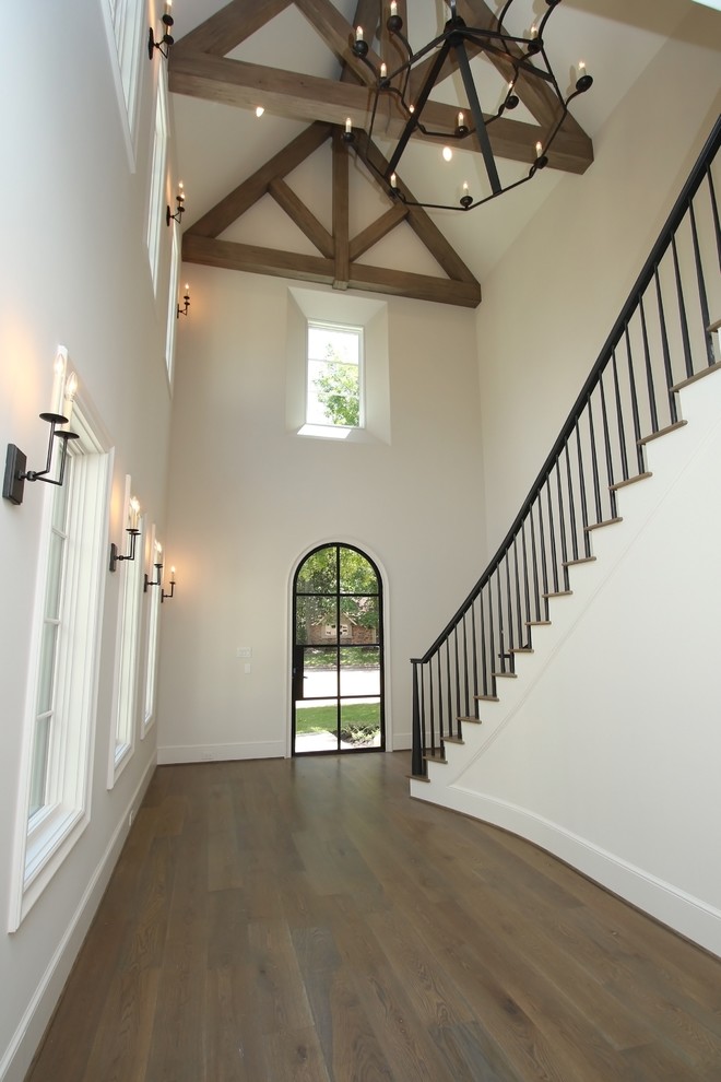 Design ideas for an expansive transitional foyer in Houston with a single front door, a black front door, white walls and medium hardwood floors.