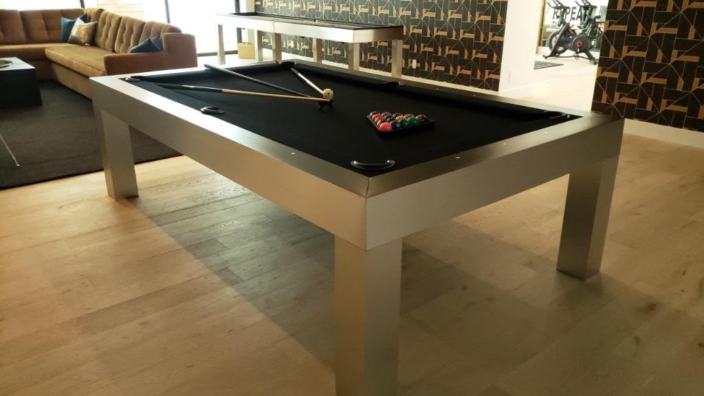 Contemporary pool table and matching shuffleboard for home staging