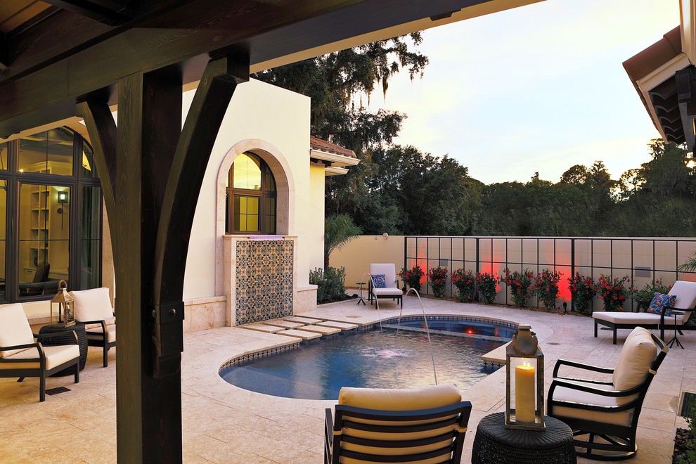 Design ideas for a small mediterranean side yard custom-shaped natural pool in Tampa with a water feature and tile.