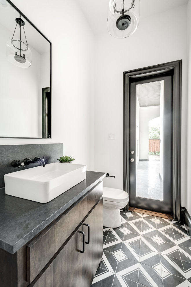 Inspiration for a contemporary powder room in Dallas with flat-panel cabinets, dark wood cabinets, a two-piece toilet, white walls, ceramic floors, a vessel sink, concrete benchtops, multi-coloured floor and grey benchtops.