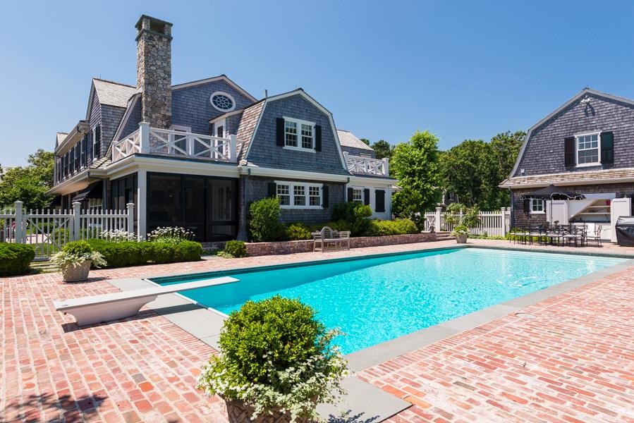 Large side yard brick and rectangular pool photo in Boston