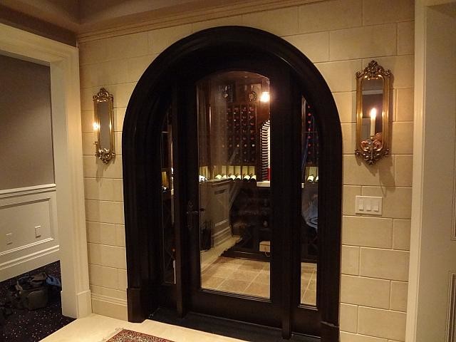 Inspiration for a mid-sized traditional wine cellar in Toronto with limestone floors, diamond bins and beige floor.