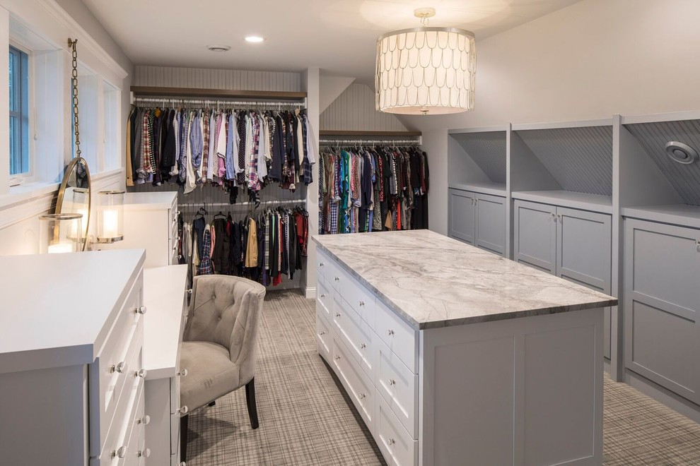 Large transitional gender-neutral walk-in wardrobe in Minneapolis with shaker cabinets, white cabinets and carpet.