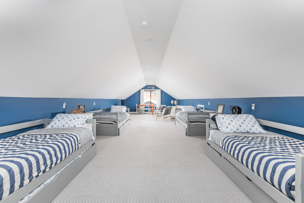 Photo of a beach style gender-neutral kids' bedroom in Indianapolis with blue walls, carpet and grey floor.