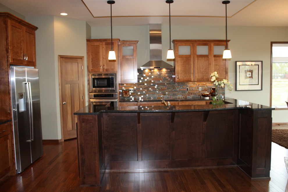 Inspiration for a mid-sized transitional l-shaped medium tone wood floor open concept kitchen remodel with an undermount sink, recessed-panel cabinets, medium tone wood cabinets, granite countertops, multicolored backsplash, mosaic tile backsplash, stainless steel appliances and an island