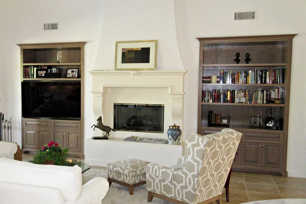 This is an example of a large traditional formal open concept living room in Los Angeles with white walls, ceramic floors, a standard fireplace, a concrete fireplace surround and a built-in media wall.