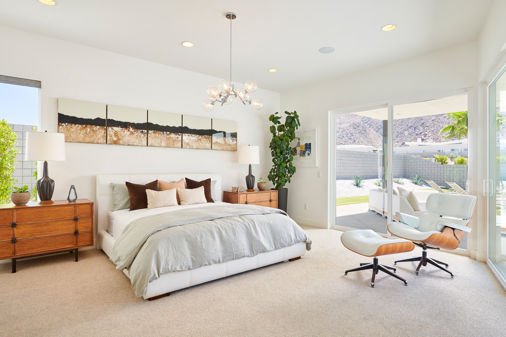 Midcentury master bedroom in Orange County with white walls, carpet, no fireplace and beige floor.