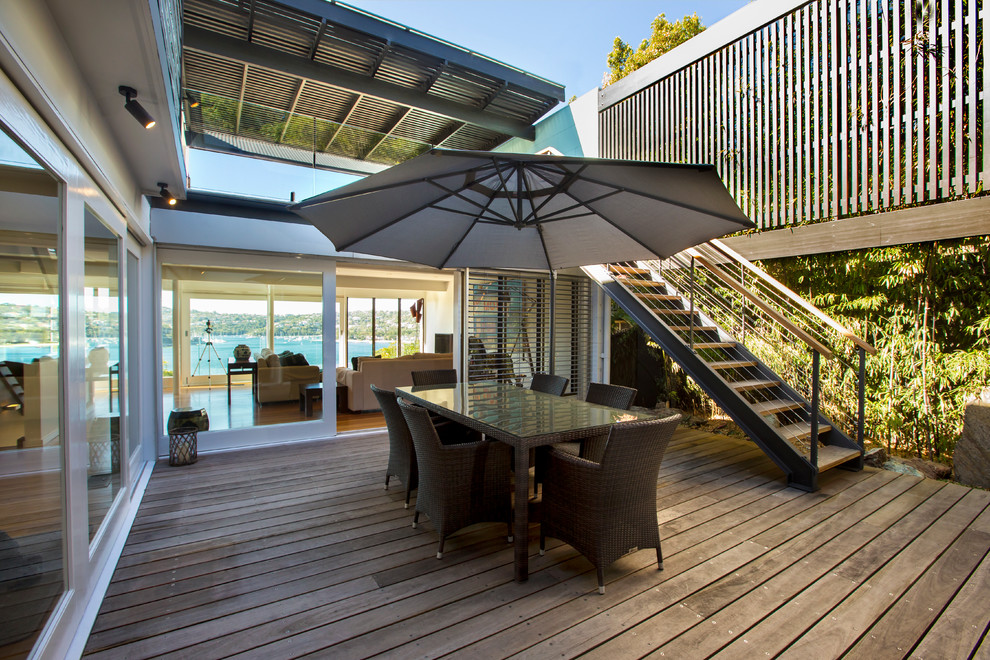 Contemporary courtyard patio in Sydney with decking and no cover.
