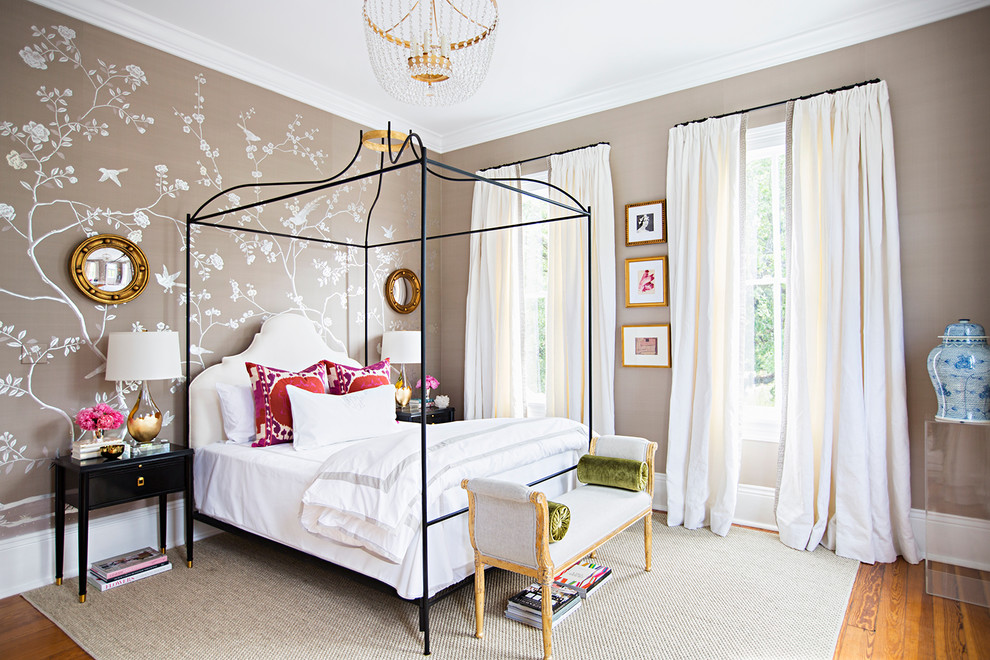Inspiration for a mid-sized transitional medium tone wood floor bedroom remodel in Houston with brown walls and no fireplace