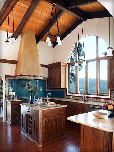 Inspiration for a large mediterranean kitchen in San Francisco with an undermount sink, beaded inset cabinets, medium wood cabinets, granite benchtops, blue splashback, ceramic splashback, stainless steel appliances, terra-cotta floors and with island.