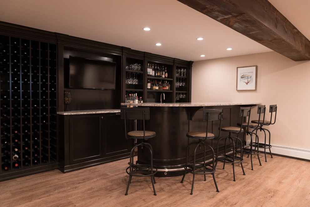 Inspiration for a mid-sized country galley seated home bar in New York with an undermount sink, recessed-panel cabinets, dark wood cabinets and quartzite benchtops.