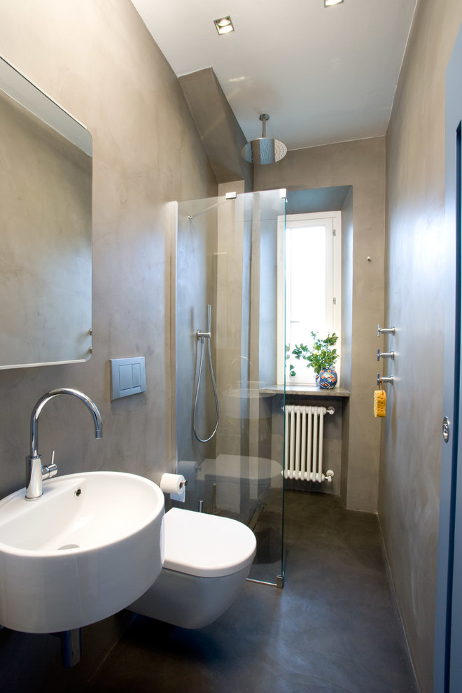 Mid-sized contemporary bathroom in Rome with a wall-mount toilet, grey walls, a wall-mount sink and grey floor.