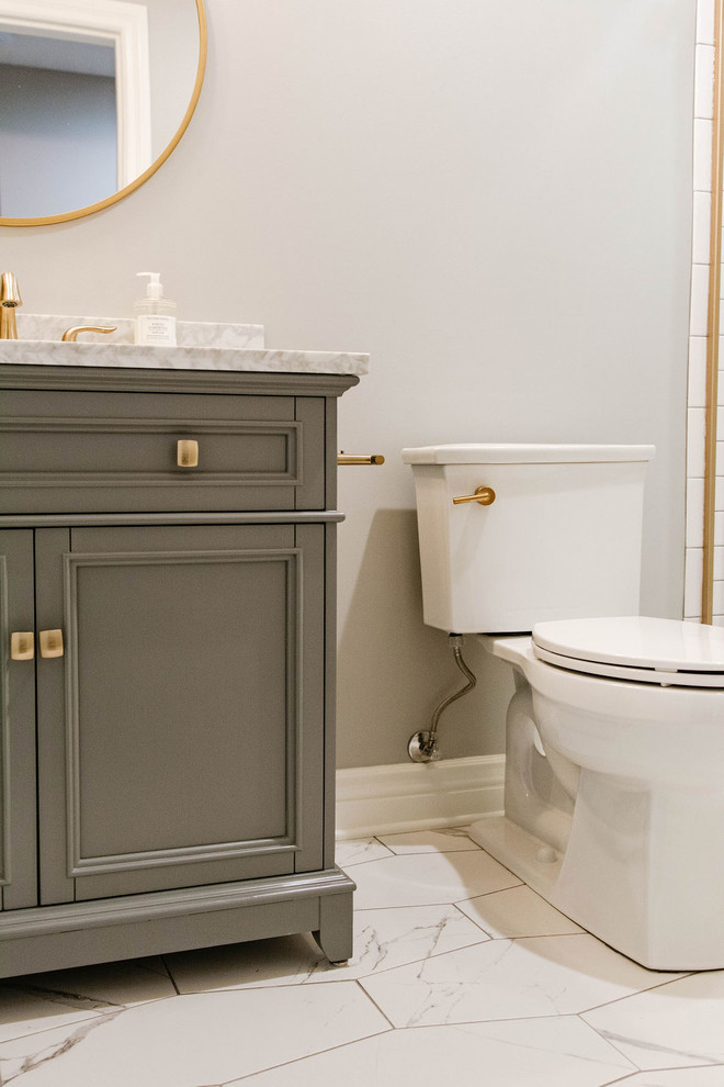 Photo of a small transitional 3/4 bathroom in Omaha with furniture-like cabinets, grey cabinets, an alcove shower, a two-piece toilet, white tile, subway tile, beige walls, an undermount sink, marble benchtops, white floor, a sliding shower screen and white benchtops.