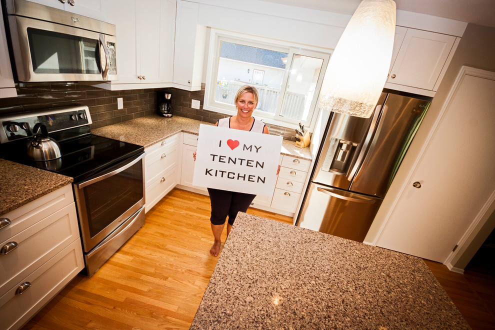 Example of a mid-sized transitional l-shaped light wood floor eat-in kitchen design with a double-bowl sink, shaker cabinets, white cabinets, quartz countertops, brown backsplash, ceramic backsplash, stainless steel appliances and an island
