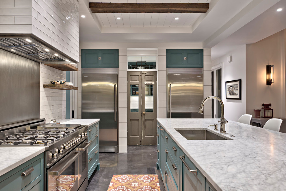 Photo of a large country galley open plan kitchen in Austin with an undermount sink, open cabinets, blue cabinets, marble benchtops, white splashback, subway tile splashback, stainless steel appliances, with island, concrete floors, grey floor and white benchtop.