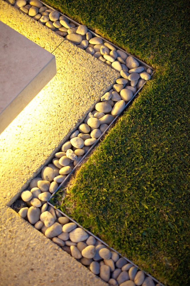 This is an example of a mid-sized modern front yard garden in Perth with concrete pavers and with lawn edging.