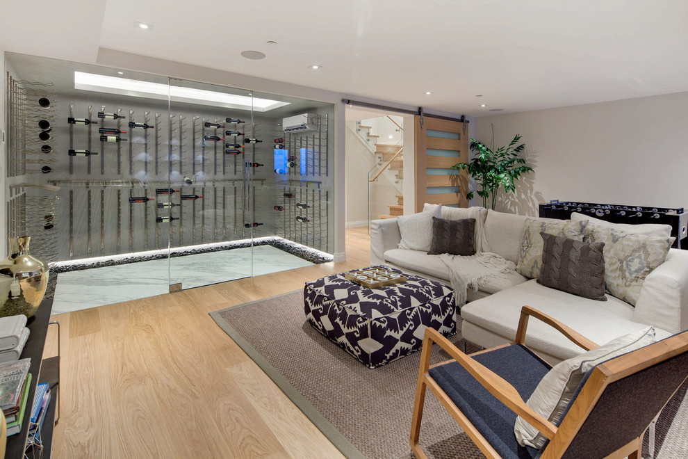 This is an example of a contemporary enclosed family room in San Francisco with a game room and light hardwood floors.