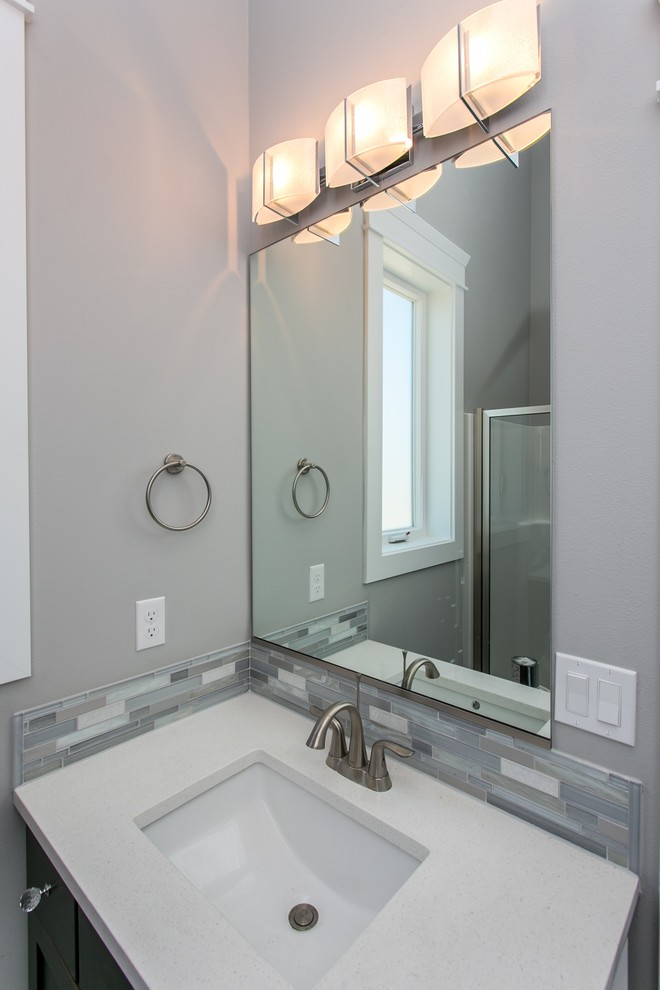 Inspiration for a small transitional 3/4 gray tile and mosaic tile porcelain tile and gray floor alcove shower remodel in Seattle with shaker cabinets, dark wood cabinets, a two-piece toilet, gray walls, an undermount sink, quartz countertops, a hinged shower door and white countertops