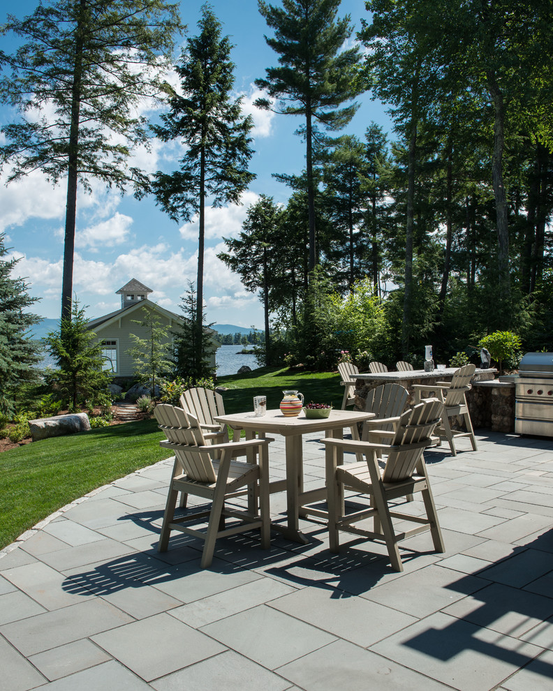 Inspiration for a large transitional backyard patio in Burlington with an outdoor kitchen, tile and no cover.