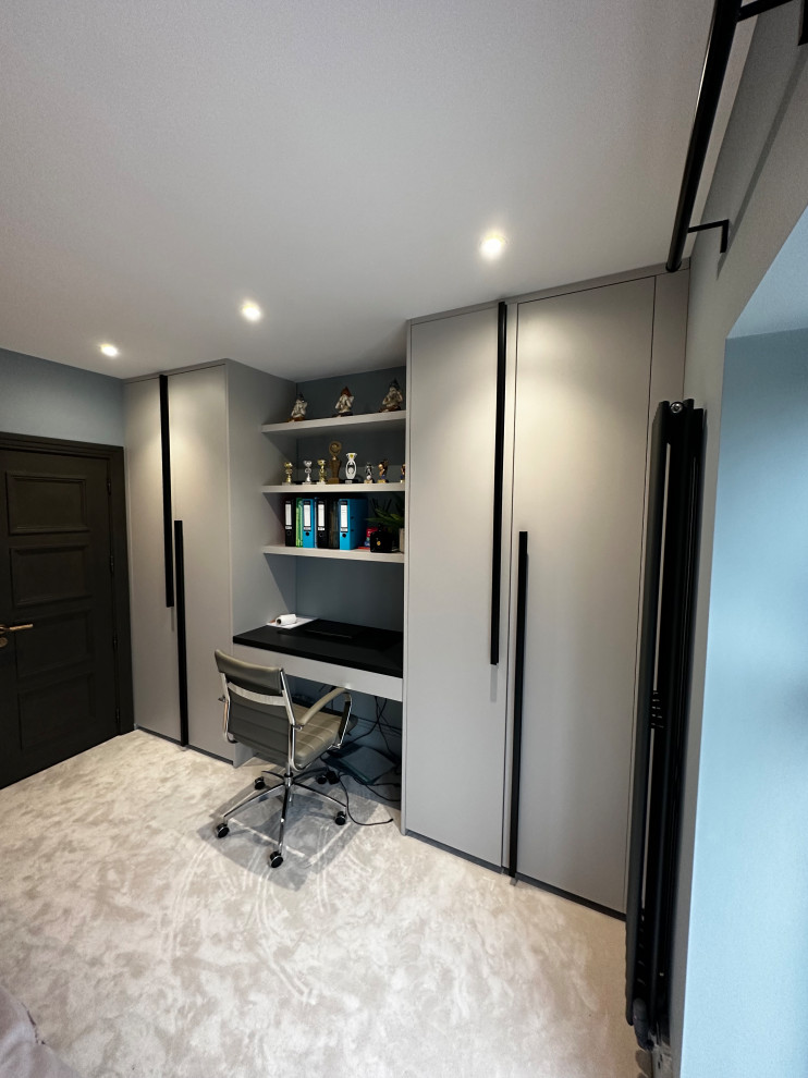 Contemporary home office in Hertfordshire with a built-in desk.
