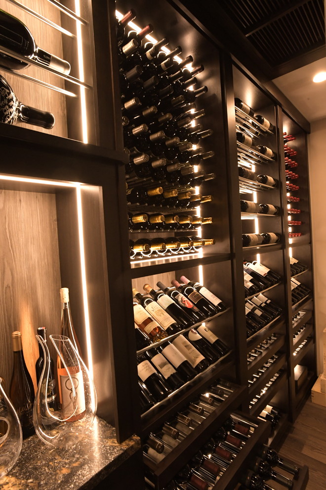 Design ideas for a large contemporary wine cellar in Orange County with medium hardwood floors, display racks and brown floor.