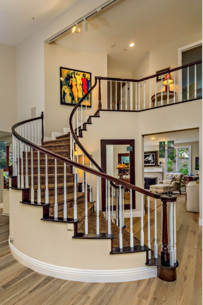 This is an example of a traditional concrete staircase in San Diego with wood risers and wood railing.
