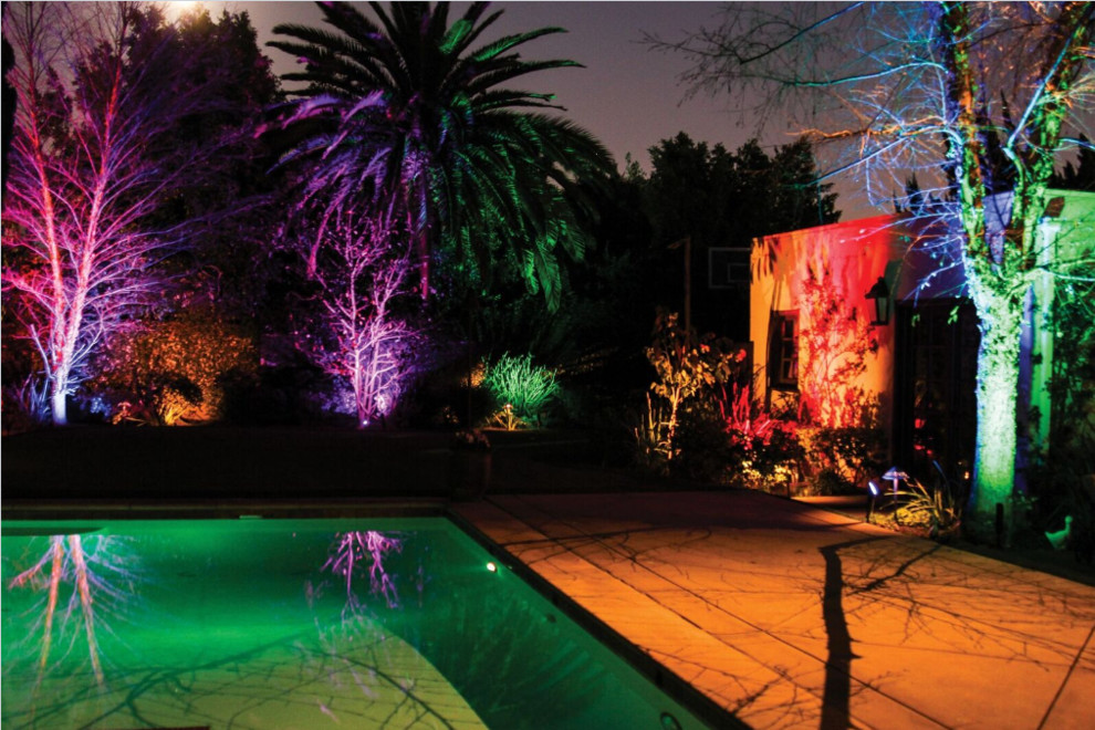 This is an example of a large tropical backyard partial sun garden in Los Angeles with a fire feature and mulch.
