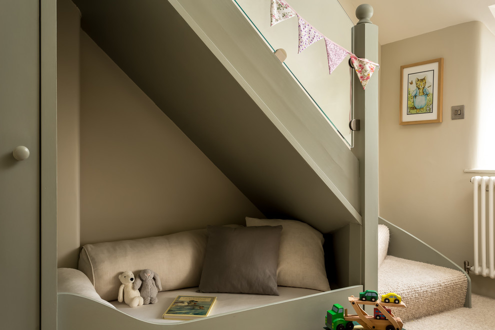 This is an example of a small country gender-neutral kids' playroom in Gloucestershire with carpet, beige floor and beige walls.