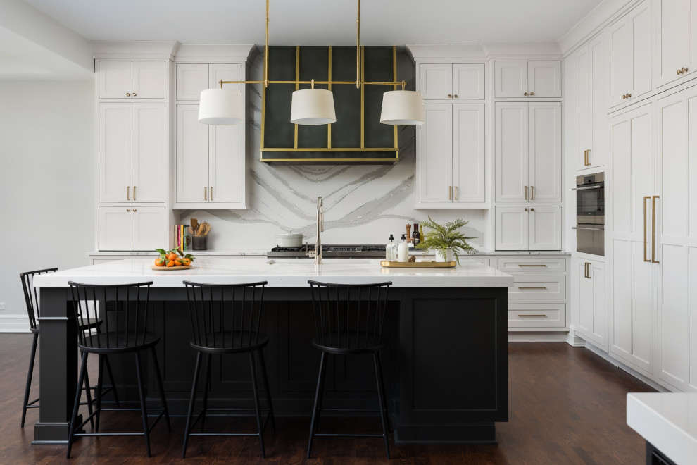 Inspiration for a large transitional l-shaped open plan kitchen in Chicago with an undermount sink, flat-panel cabinets, white cabinets, quartz benchtops, white splashback, engineered quartz splashback, panelled appliances, dark hardwood floors, multiple islands, brown floor, white benchtop and coffered.