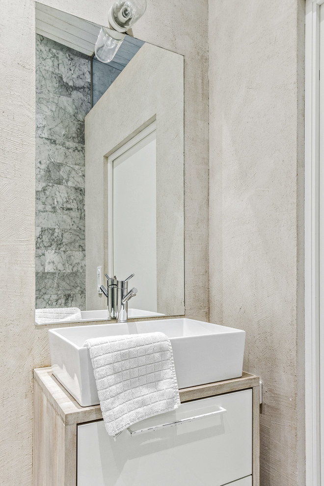 This is an example of a small scandinavian 3/4 bathroom in Stockholm with a drop-in tub, a corner shower, a wall-mount toilet, marble, marble floors, wood benchtops and an open shower.
